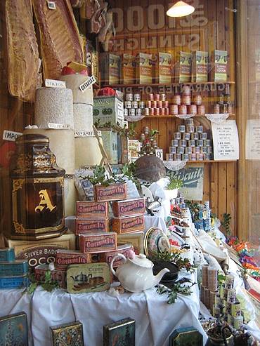 Cheeses, tea, bacon in shop window
